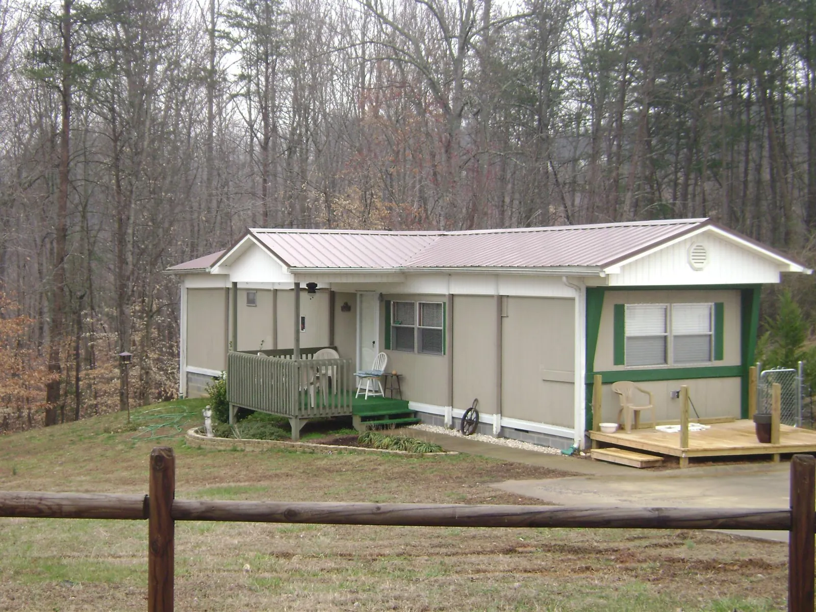 Mauve metal roof on a manufactured home with a new front deck in Fergus Falls